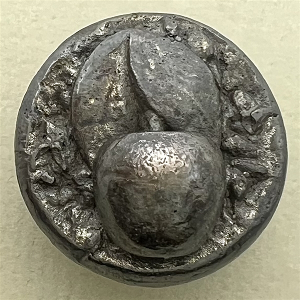 Metalized molded plastic button of a cherry.