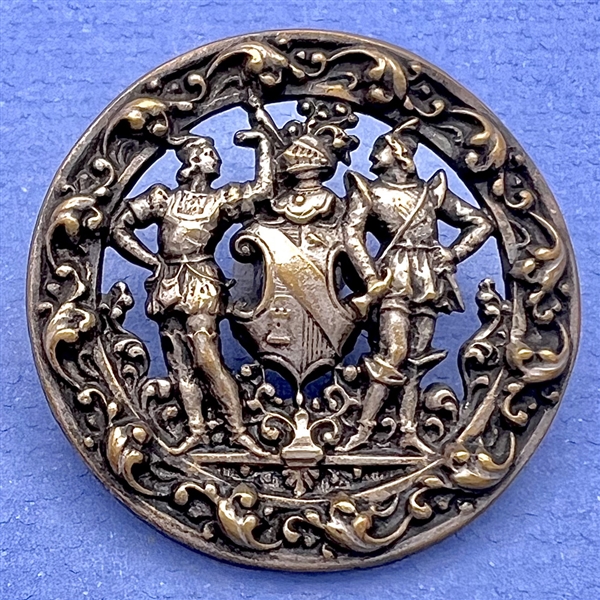 Brass button of two supporters and a shield and helm.