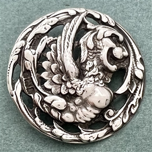 Hallmarked silver button of a fabulous creature.