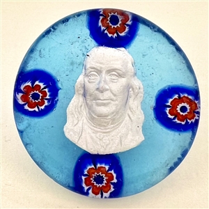 Glass studio paperweight button with sulphide of Benjamin Franklin by Theresa Rarig.