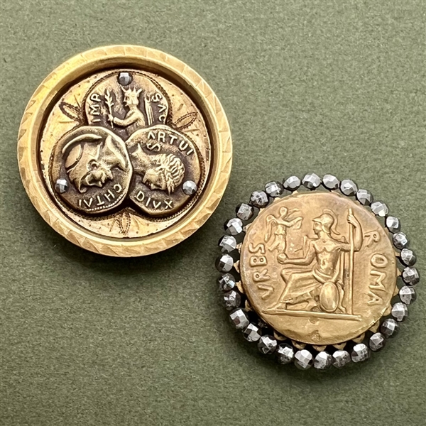 Two coin-like brass buttons of Roman coins.