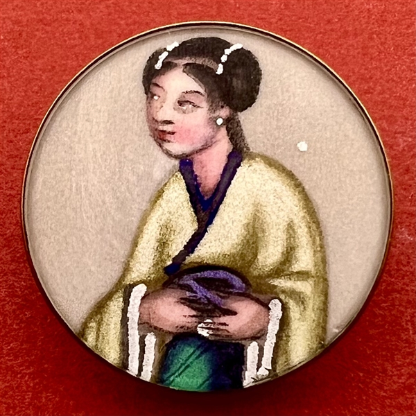 Painting on fabric button of an Asian woman.