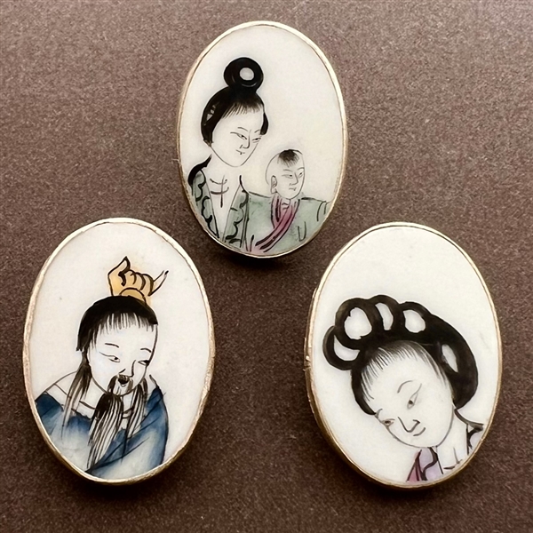 Three shard ceramic buttons of Asians, mostly children.