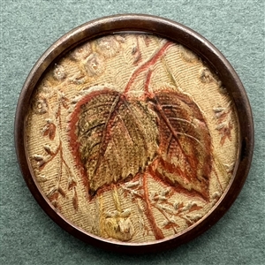 An 18th c. Worked leather under glass button of leaves.