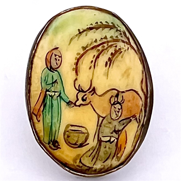 Painting on natural material button set in sterling of woman and man milking a cow.