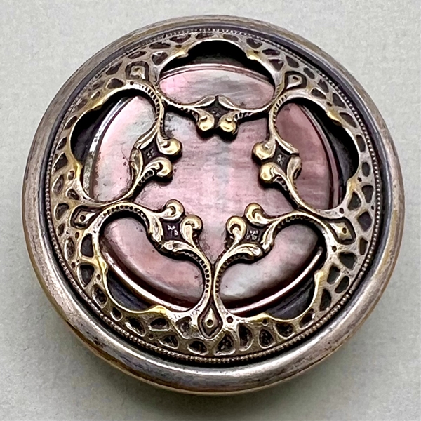 Arts and crafts brass design over shell button.