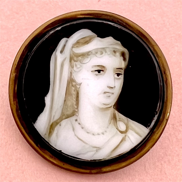 Transfer and painted glass in metal button of a woman.