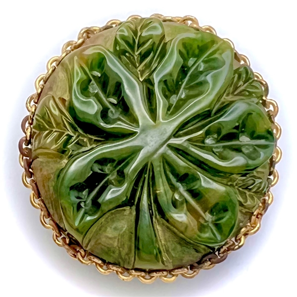 Carved jade button of leaves.