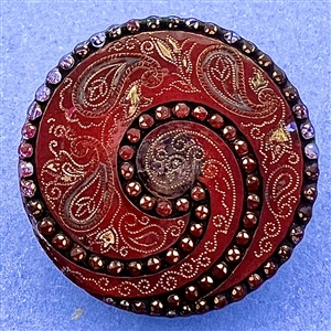 Lacy glass button in paisley pattern.