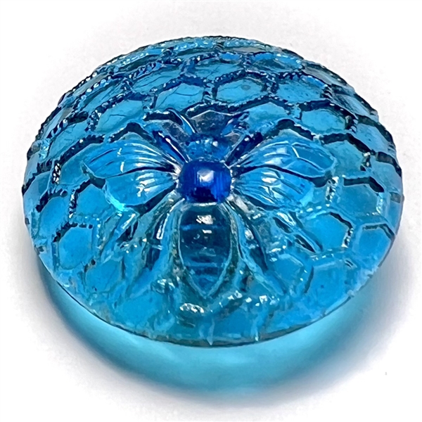 Blue glass button of honeycomb and bee.