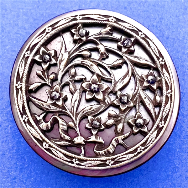 Victorian open work design of flowers over pearl button.