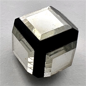 Black glass cube button with clear glass mirrored insets.