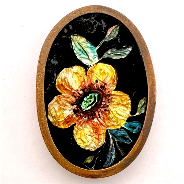 Painted foil under glass oval button of a flower.