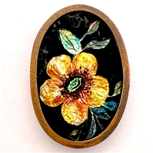 Painted foil under glass oval button of a flower.