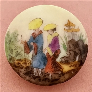 Glazed porcelain button of two Asian woman in garden setting.