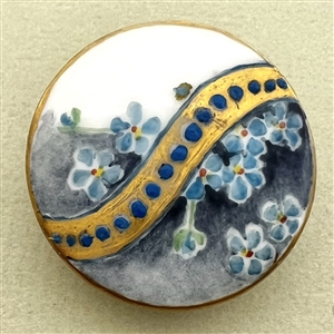 Painted porcelain button of forget-me-not flowers.