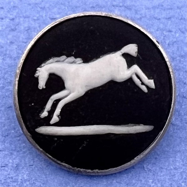 Wedgewood button of a jumping horse set in hallmarked silver.