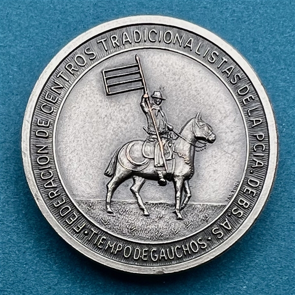 Argentinian gaucho (cowboy) on horseback with flag button.