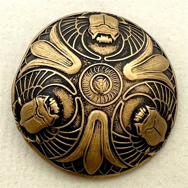 Brass button with three Egyptian scarabs.