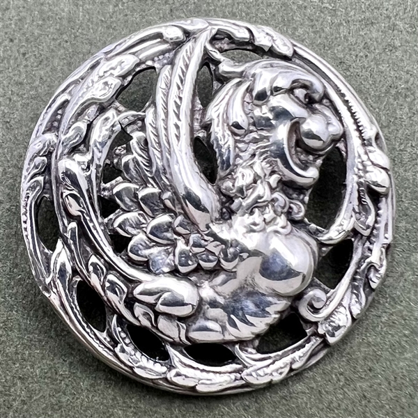 Hallmarked silver button of a fabulous creature.