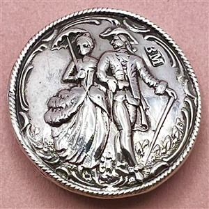 Hallmarked silver button of a couple walking.