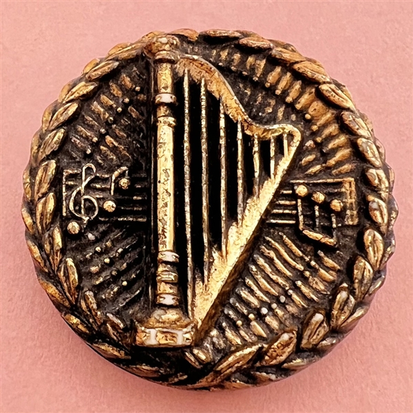 Metalized plastic Diamond D button of harp and music notes.