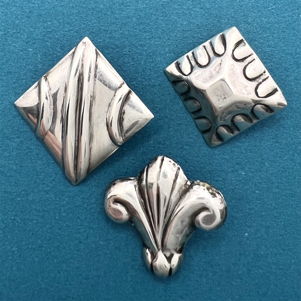 Three Mexican sterling silver buttons.