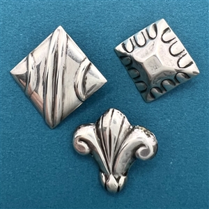 Three Mexican sterling silver buttons.