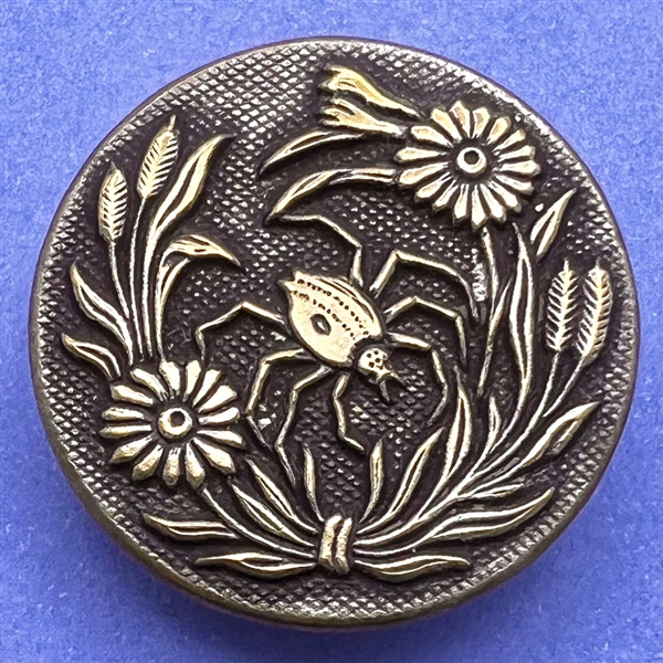 Brass button of spider among flowers. 