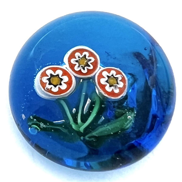 Glass paperweight studio button of flowers.