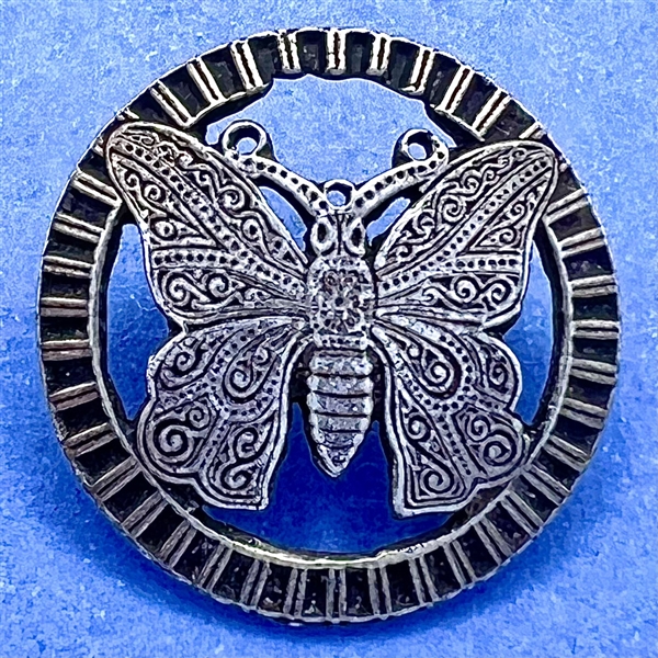 White metal button of a butterfly.