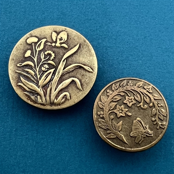 Two brass buttons (one is Paris back) with butterfly and plant.