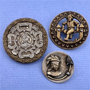 Three brass people buttons including a Kate Greenaway.