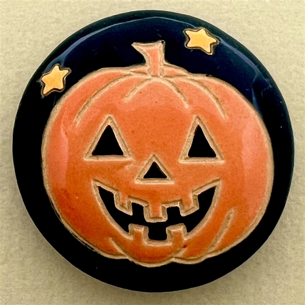 Ceramic Halloween pumpkin button by Golem Design Studio.