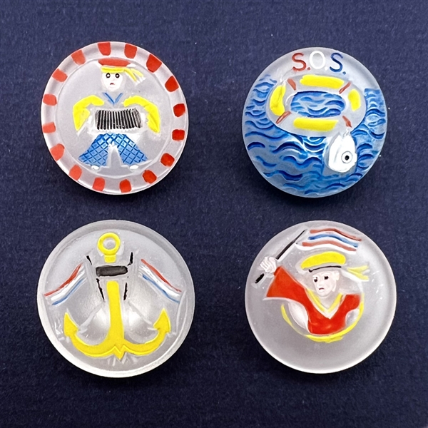 Set of four frosted clear glass buttons of nautical themes.