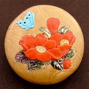 Shibayama button of plant life and a butterfly.