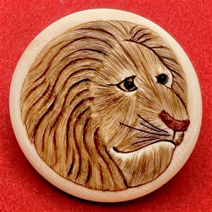 Natural material button of a lion’s head.