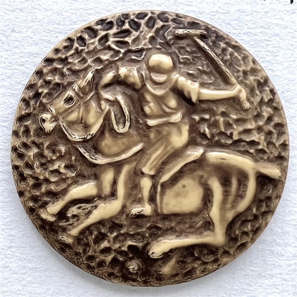 Vintage celluloid button of polo player on a horse.