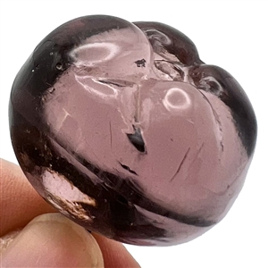 Sculptural transparent purple glass button of a pepper. 