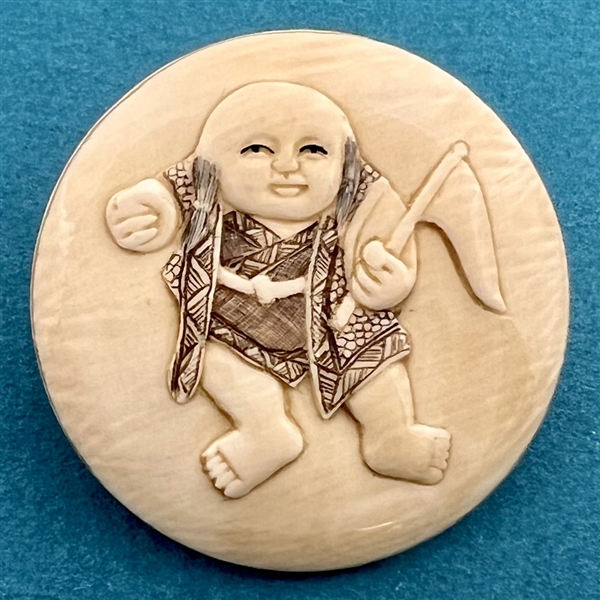 Natural material button of an Asian boy waving a flag.