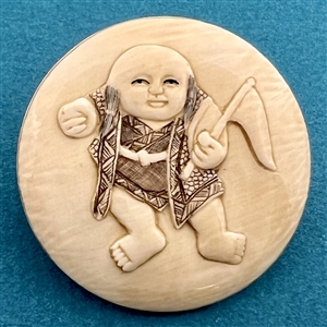 Natural material button of an Asian boy waving a flag.