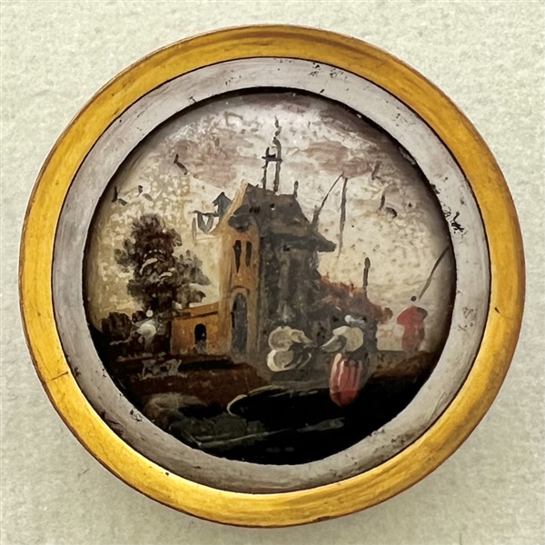 An 18th c. painting under glass of a village scene with people button.