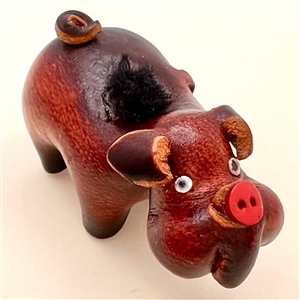 Large realistic leather pig button. 