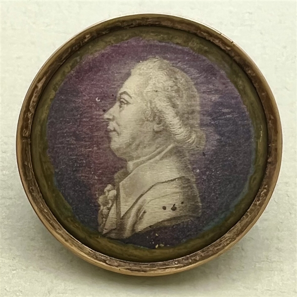 An 18th c. Silk under glass button of a man in profile.