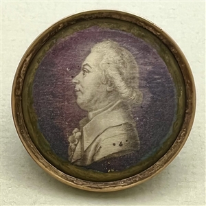 An 18th c. Silk under glass button of a man in profile.