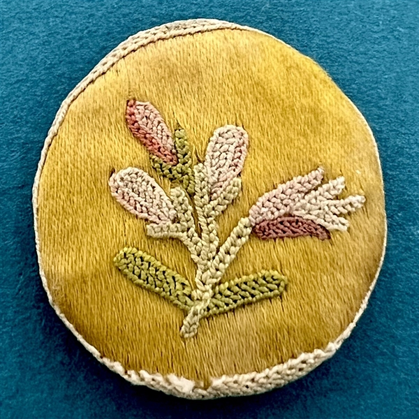 A 19th c. Fabric button of flowers.