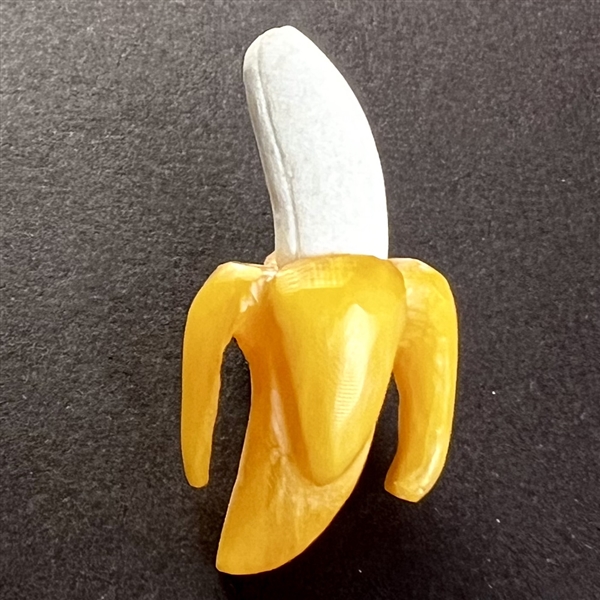 Carved Bakelite studio button of peeled banana by Richard Carpenter.