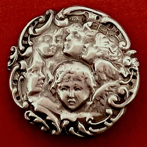 Hallmarked silver button of five cherub heads.