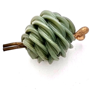 Vintage celluloid button of realistic yarn and knitting needles.