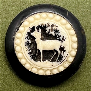 Carved natural material French sporting button of a deer.